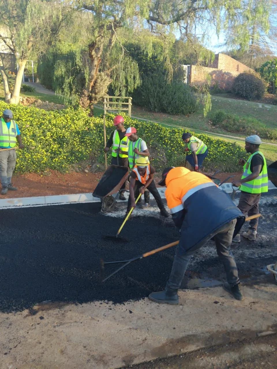 Team executing asphalt paving