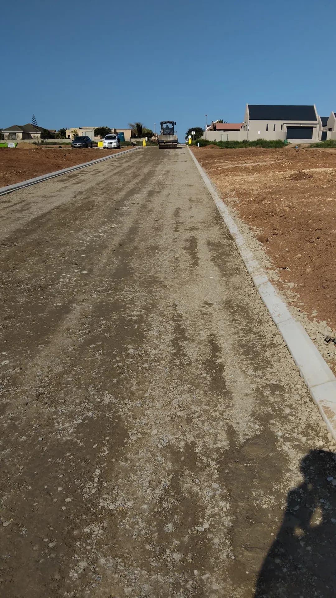 Prepared road base between new concrete kerbs