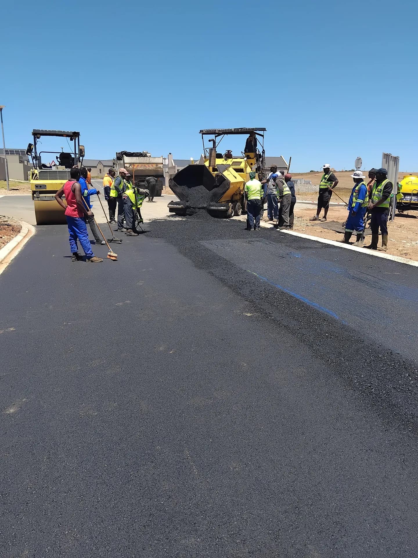 Crew working alongside the asphalt paver